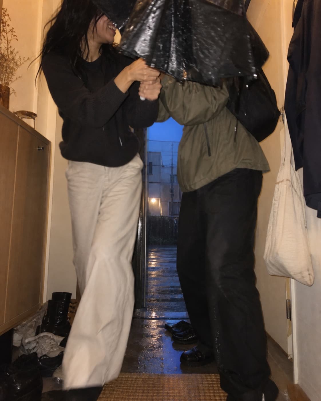 A couple holding each other in a narrow street at night